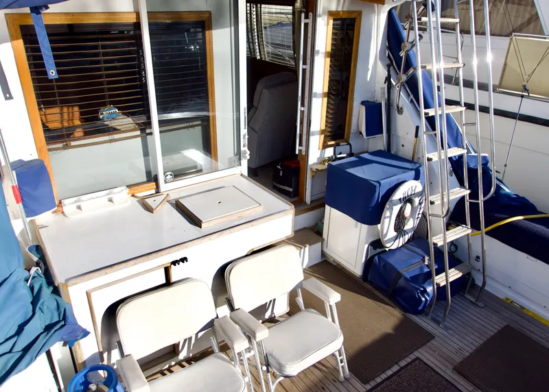 Slide: The Image of 1986 Bertram 46 Sportfisher interior with seating, ladder, and equipment. - 8
