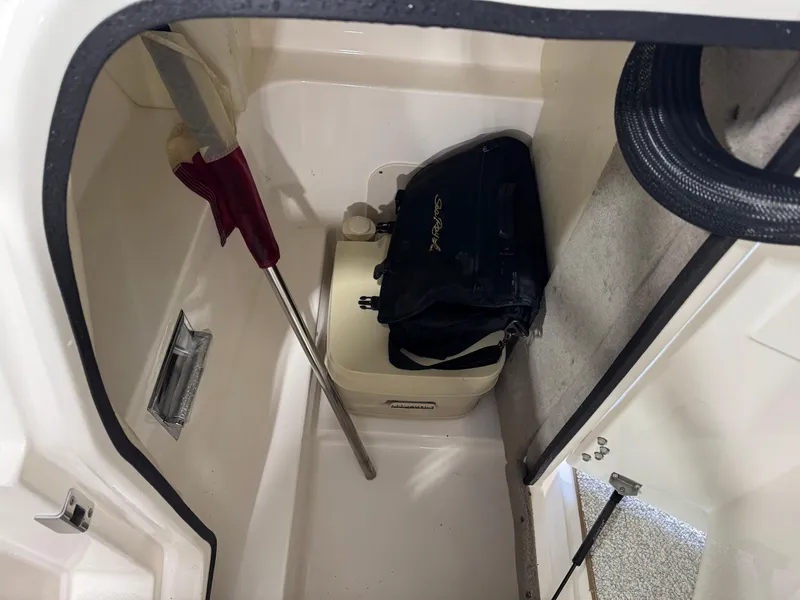 Slide: The Image of Storage compartment in a 2007 Sea Ray 250 SLX boat with equipment and a bag. - 12