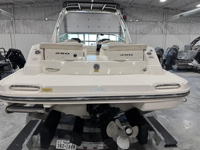 Slide: The Image of 2007 Sea Ray 250 SLX boat in a showroom, rear view with propeller visible. - 16