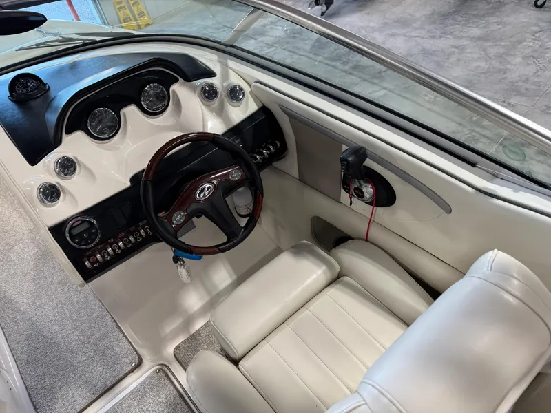 Slide: The Image of 2007 Sea Ray 250 SLX boat cockpit with leather seating and modern dashboard controls. - 8