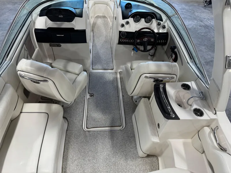 Slide: The Image of Interior of a 2007 Sea Ray 250 SLX boat with white seating and dashboard. - 9
