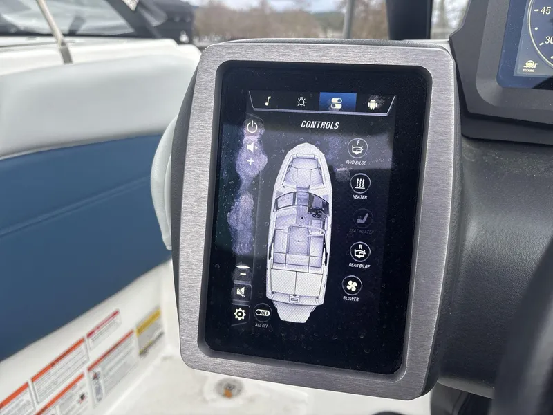 Slide: The Image of Touchscreen control panel on a 2022 Malibu 21lx boat, displaying various system settings. - 11
