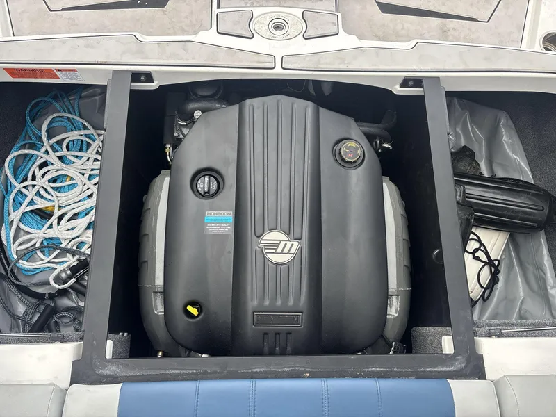 Slide: The Image of 2022 Malibu 21lx boat engine compartment with ropes and equipment. - 18