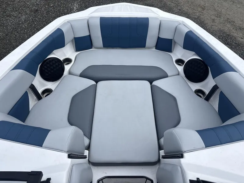 Slide: The Image of 2022 Malibu 21lx boat interior with blue and gray cushioned seating. - 6
