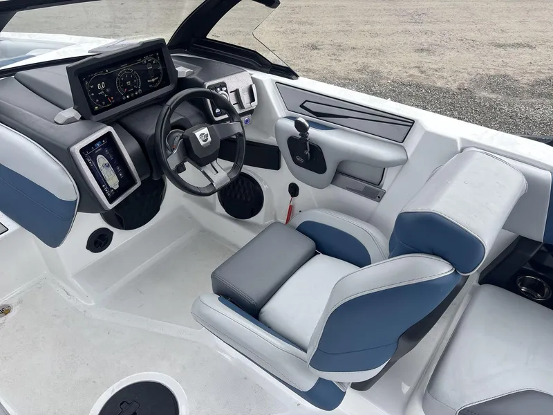 Slide: The Image of 2022 Malibu 21lx boat interior with modern dashboard and blue-gray seating. - 9