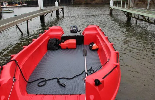 Slide: The Image of Red Whaly 500R Pro boat, 2025 model, docked with equipment on board. - 11
