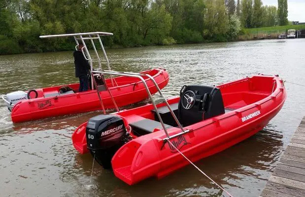 Slide: The Image of Red 2025 Whaly 500R Pro boats on a river, featuring Mercury and Honda engines. - 13