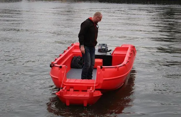 Slide: The Image of Red Whaly 500R Pro boat on water, 2025 model, with person standing onboard. - 8
