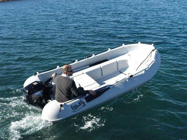 Slide: The Image of A person operates a 2025 Whaly 370 boat on calm blue water. - 10
