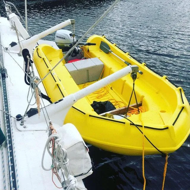 Slide: The Image of Yellow Whaly 370 boat from 2025 docked on water with Honda motor. - 3
