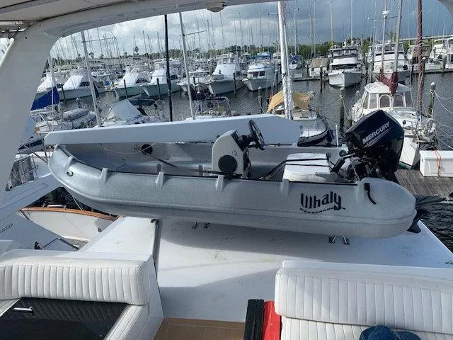Slide: The Image of 2025 Whaly 370 boat with Mercury engine on yacht deck, marina background. - 5