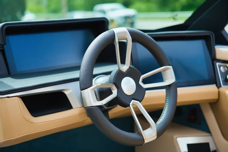 Slide: The Image of 2025 MasterCraft X22 interior with modern steering wheel and displays. - 13