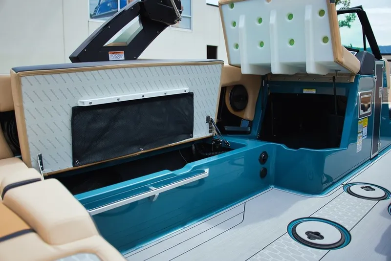 Slide: The Image of MasterCraft X22 2025 boat with open storage and blue trim. - 21
