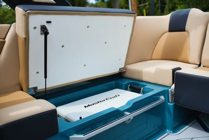 Slide: The Image of MasterCraft X22 2025 boat with open storage compartment and seating area. - 22