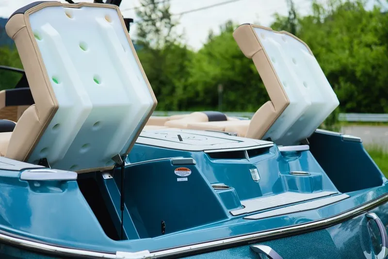 Slide: The Image of 2025 MasterCraft X22 boat with open storage compartments. - 24