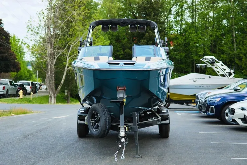 Slide: The Image of 2025 MasterCraft X22 boat on trailer parked outdoors. - 26