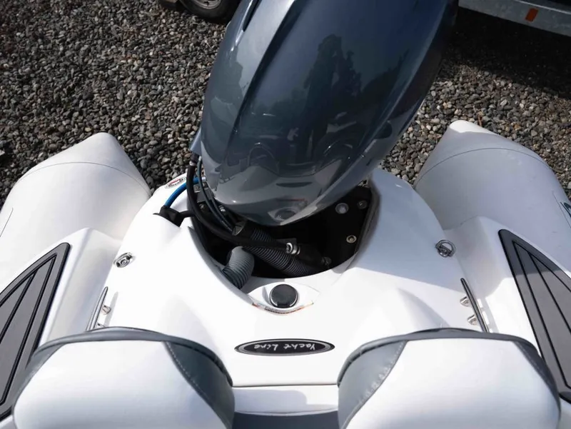 Slide: The Image of Zodiac Yachtline 360 2024 with outboard motor on gravel surface. - 14