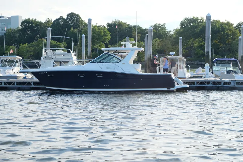 The Image of 2006 Tiara Yachts 3200 Open docked at marina, surrounded by other boats. - 0