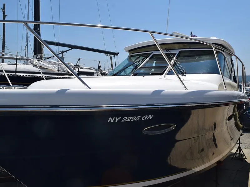 Slide: The Image of 2006 Tiara Yachts 3200 Open boat docked, featuring sleek design and registration number NY 2295 GN. - 11