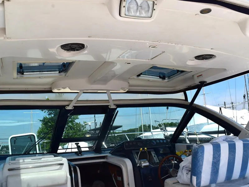 Slide: The Image of 2006 Tiara Yachts 3200 Open cockpit with striped seating and control panel. - 17