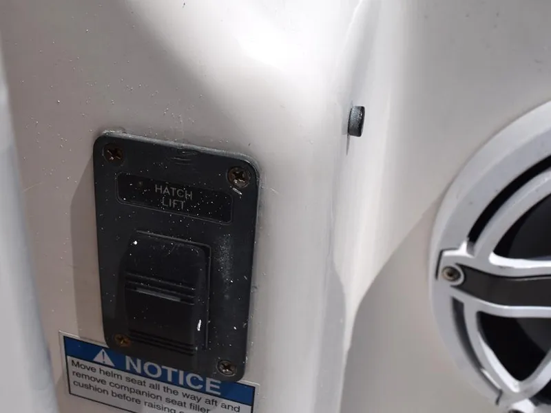 Slide: The Image of Hatch lift switch on 2006 Tiara Yachts 3200 Open, with notice label and speaker detail. - 18