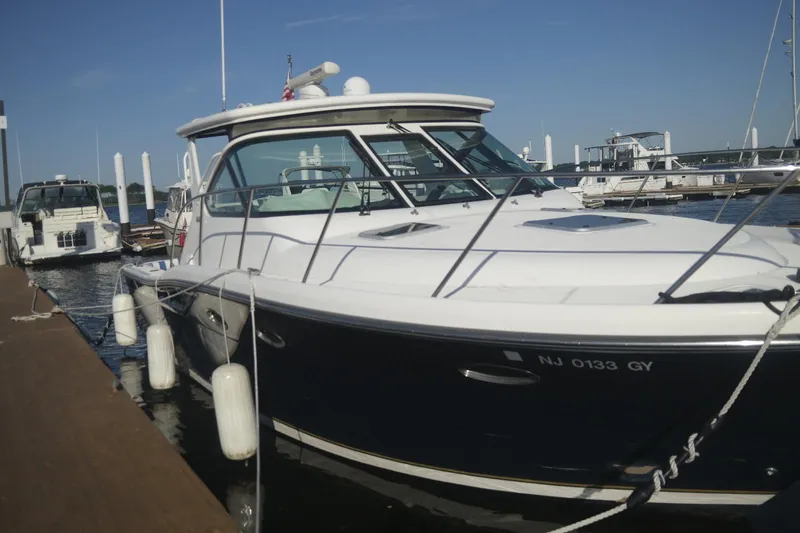 Slide: The Image of 2006 Tiara Yachts 3200 Open docked at marina, side view. - 2