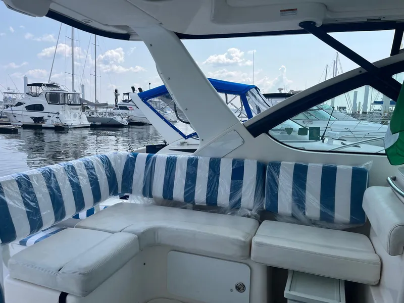 Slide: The Image of 2006 Tiara Yachts 3200 Open with striped seating, docked at a marina. - 20