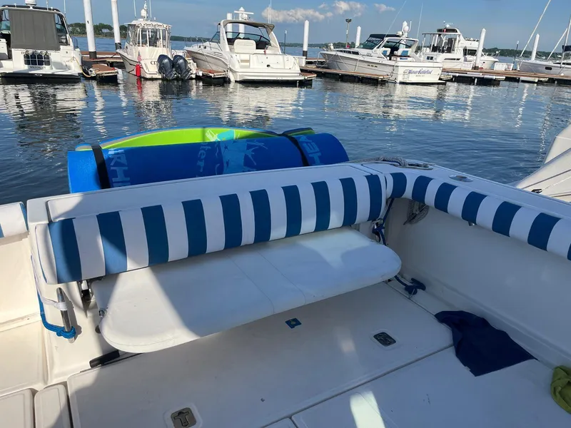 Slide: The Image of 2006 Tiara Yachts 3200 Open with striped seating at a marina. - 21