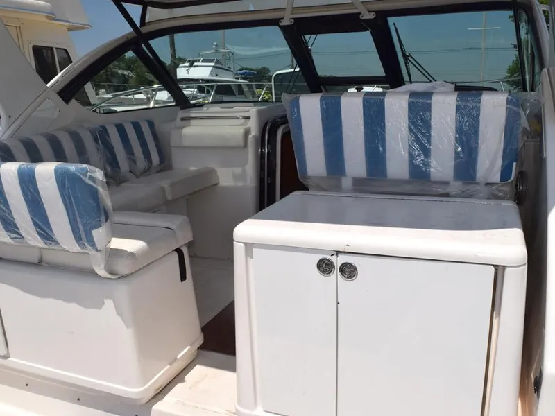 Slide: The Image of 2006 Tiara Yachts 3200 Open interior with striped seating and white cabinetry. - 22