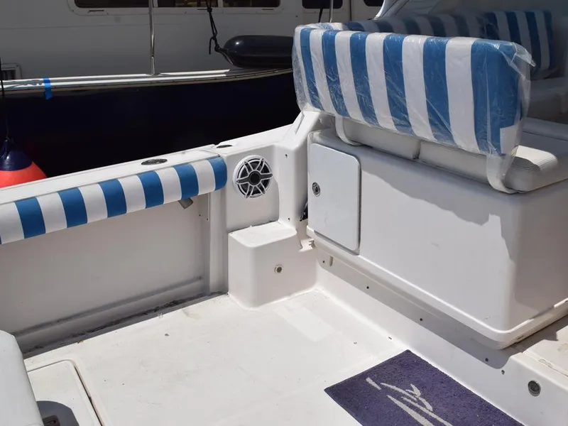 Slide: The Image of 2006 Tiara Yachts 3200 Open interior with striped seating and marine speaker. - 24