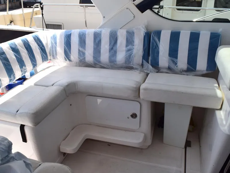 Slide: The Image of 2006 Tiara Yachts 3200 Open interior with striped seating and storage compartment. - 25