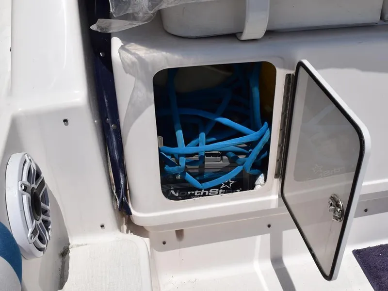 Slide: The Image of Open compartment on 2006 Tiara Yachts 3200 Open, showing blue cables and NorthStar battery. - 29