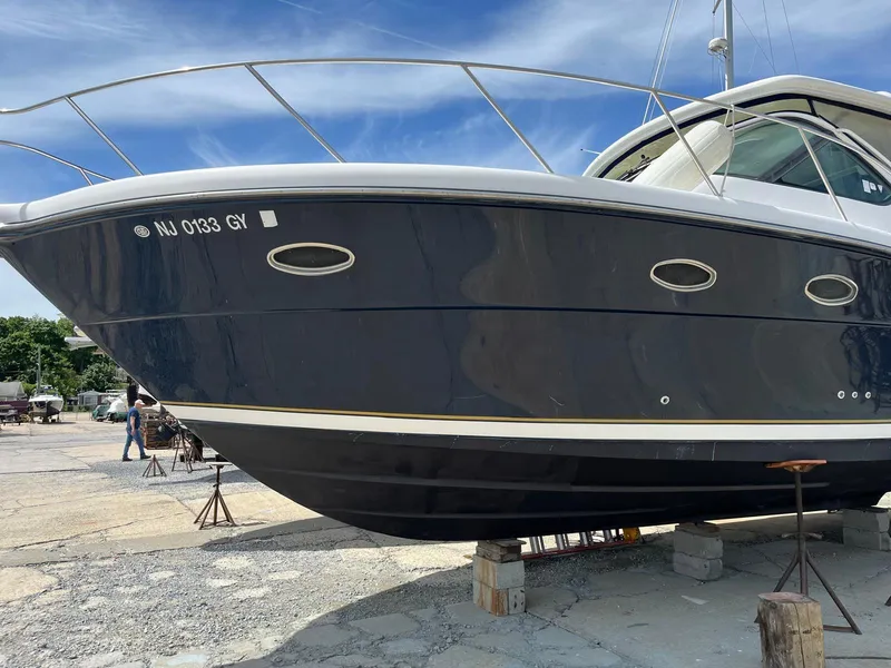 Slide: The Image of 2006 Tiara Yachts 3200 Open on dry dock, blue hull, sunny day. - 3