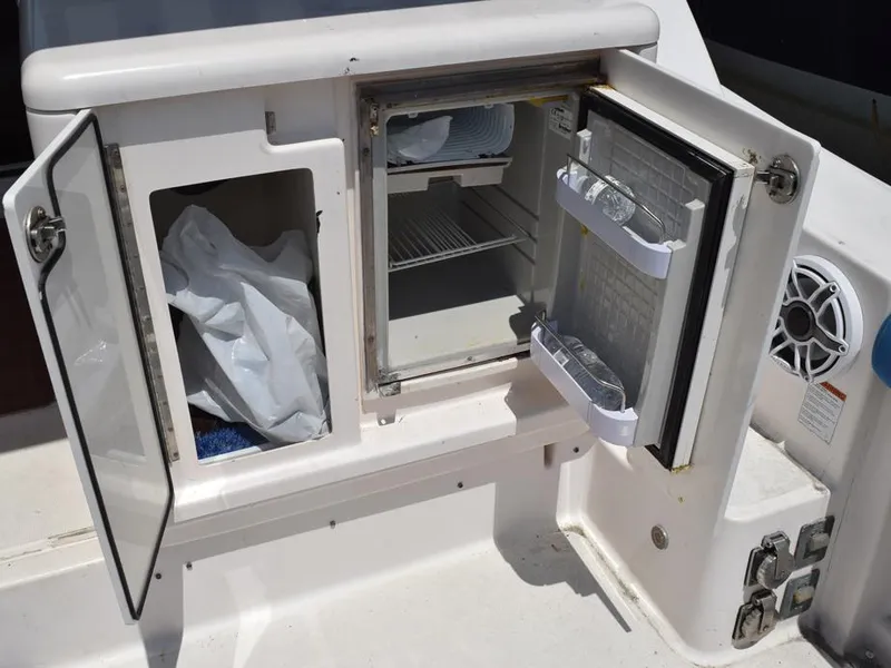 Slide: The Image of Open storage and mini fridge on 2006 Tiara Yachts 3200 Open boat. - 32