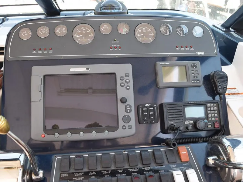 Slide: The Image of Helm dashboard of 2006 Tiara Yachts 3200 Open with navigation and communication equipment. - 37