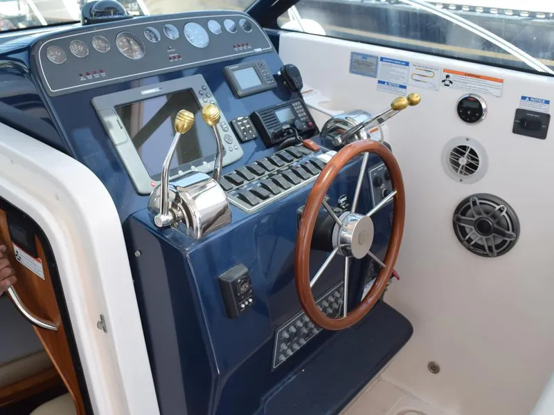 Slide: The Image of 2006 Tiara Yachts 3200 Open helm with controls, gauges, and steering wheel. - 38