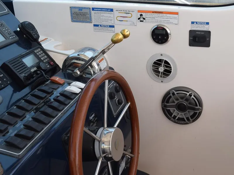 Slide: The Image of 2006 Tiara Yachts 3200 Open helm with wooden steering wheel and control panel. - 39