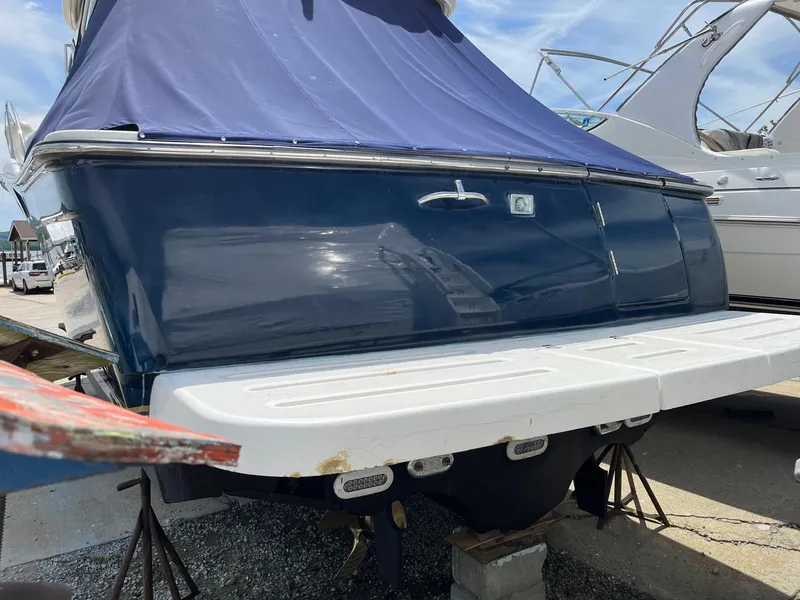 Slide: The Image of 2006 Tiara Yachts 3200 Open with blue cover, docked on land. - 4