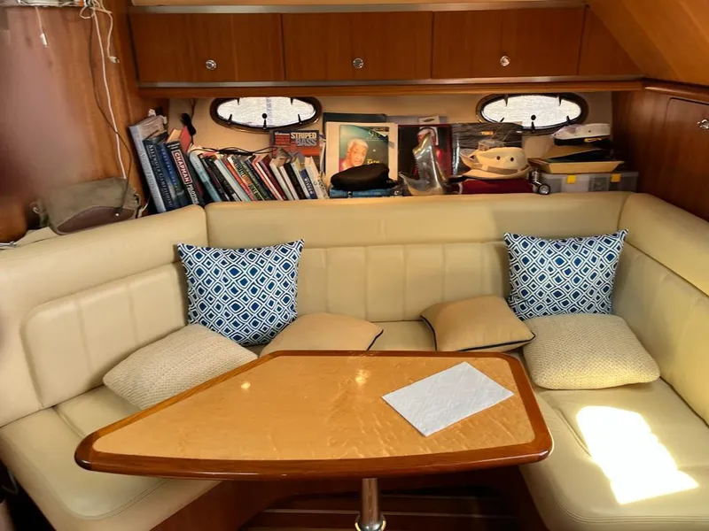 Slide: The Image of Cozy interior of 2006 Tiara Yachts 3200 Open with books and cushions. - 41