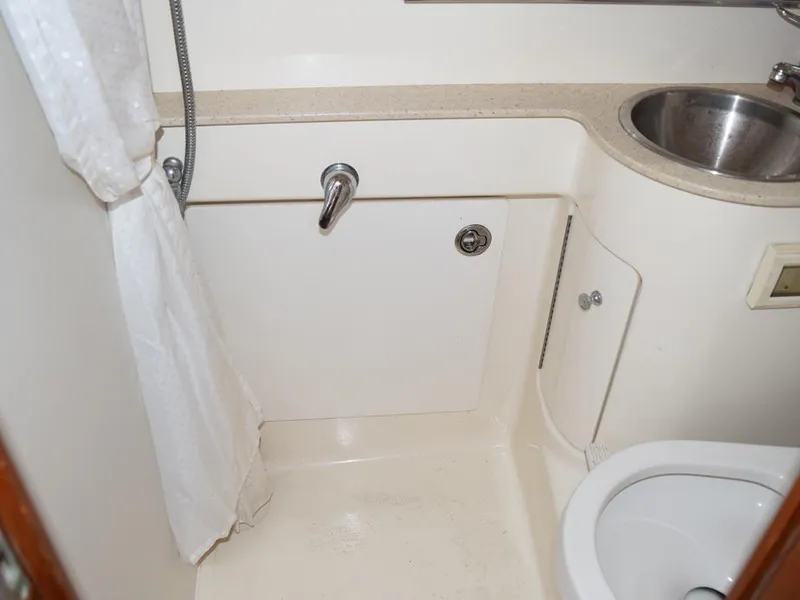 Slide: The Image of 2006 Tiara Yachts 3200 Open bathroom with shower, sink, and toilet. - 48