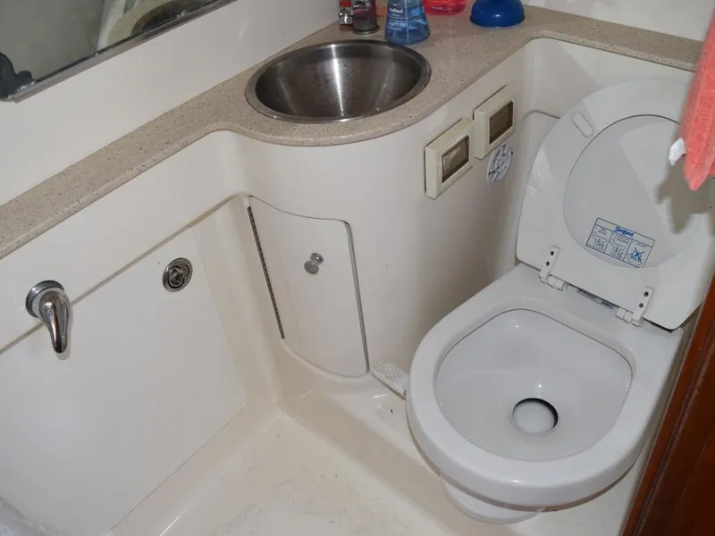Slide: The Image of Compact bathroom in 2006 Tiara Yachts 3200 Open, featuring a sink and toilet. - 49