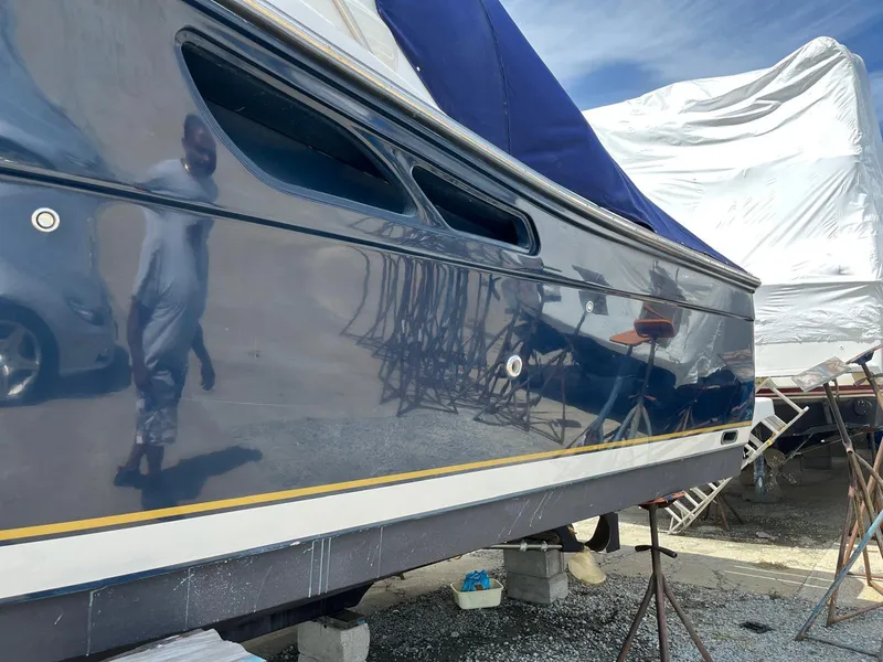 Slide: The Image of 2006 Tiara Yachts 3200 Open with polished hull, docked and covered. - 6