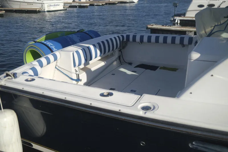 Slide: The Image of 2006 Tiara Yachts 3200 Open with striped seating, docked at a marina. - 9