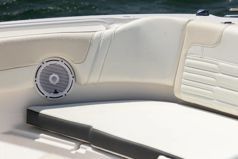 Slide: The Image of 2025 Edgewater 262 CX boat interior with cushioned seating and built-in speaker. - 14