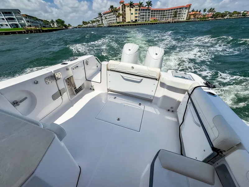 Slide: The Image of 2025 Edgewater 262 CX boat cruising on a sunny day, featuring spacious seating and dual engines. - 34