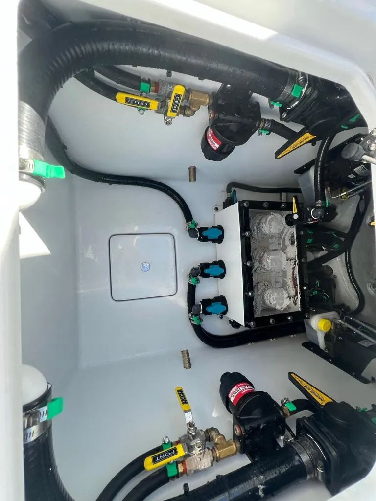 Slide: The Image of 2025 Contender 32 ST boat engine compartment with hoses and valves. - 12