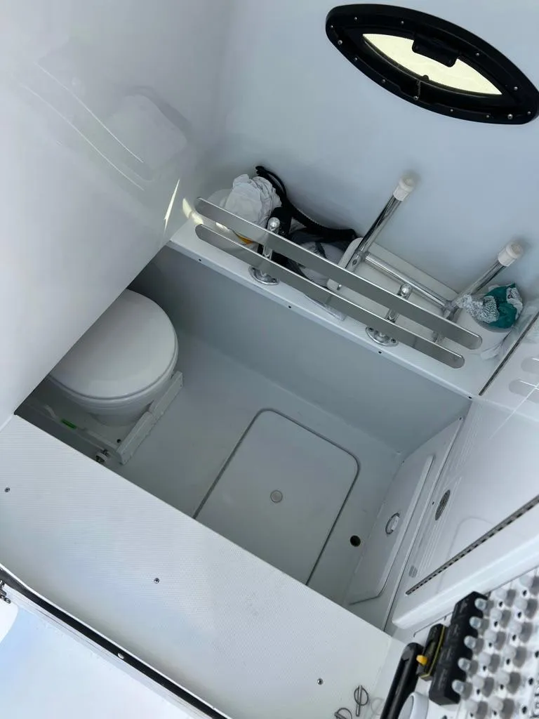 Slide: The Image of 2025 Contender 32 ST boat interior bathroom with toilet and sink. - 13