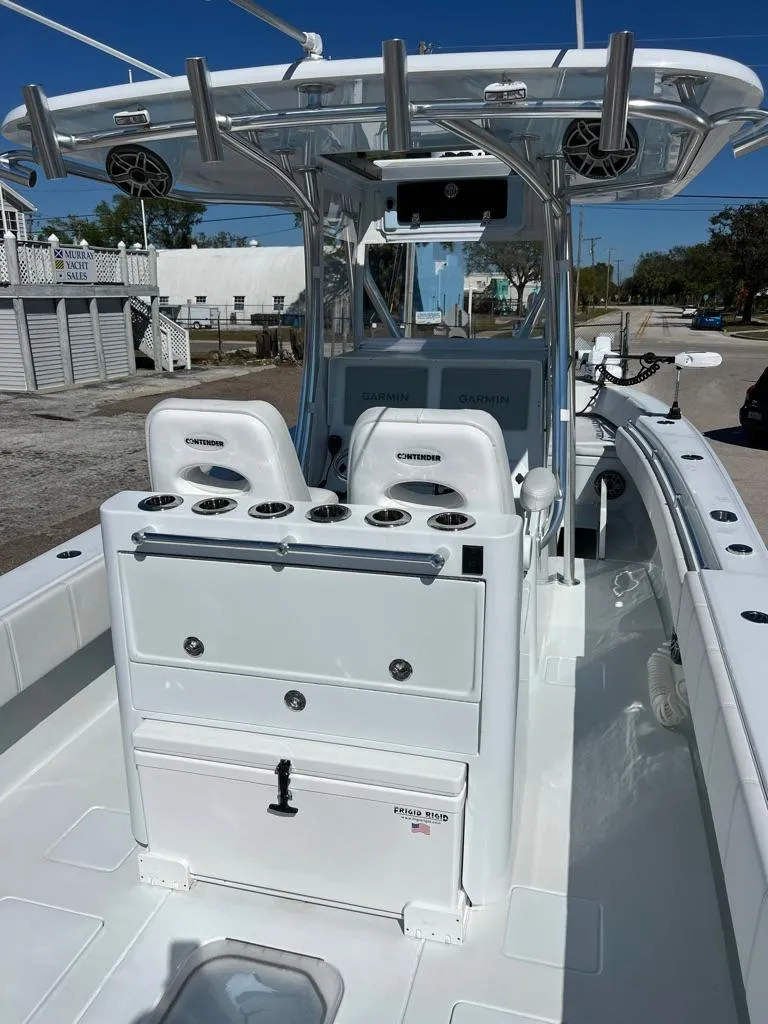 Slide: The Image of 2025 Contender 32 ST boat interior with seating and fishing rod holders. - 3
