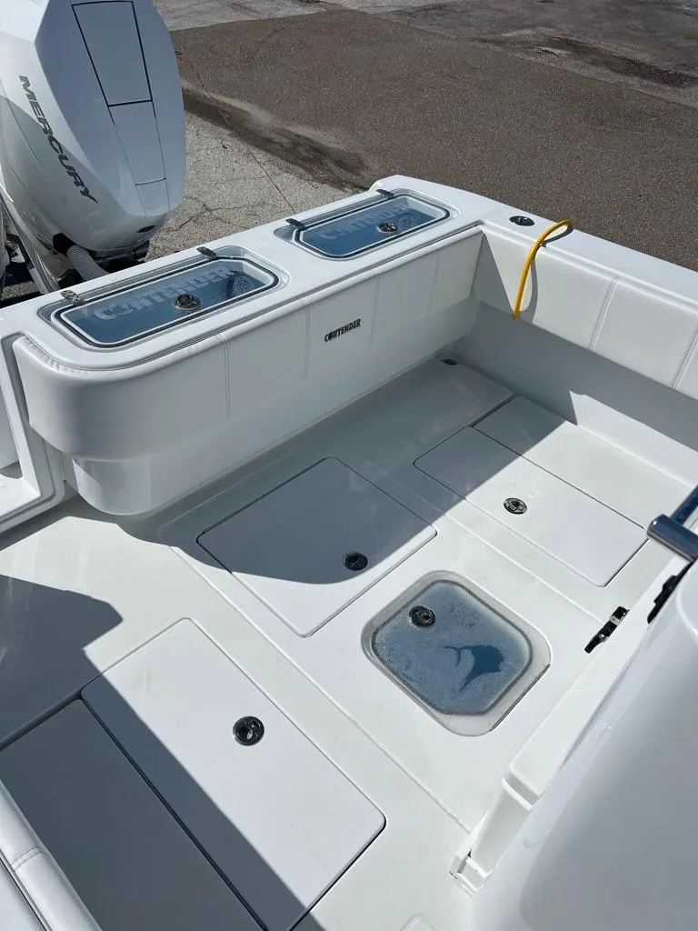 Slide: The Image of 2025 Contender 32 ST boat deck with storage compartments and live wells. - 4