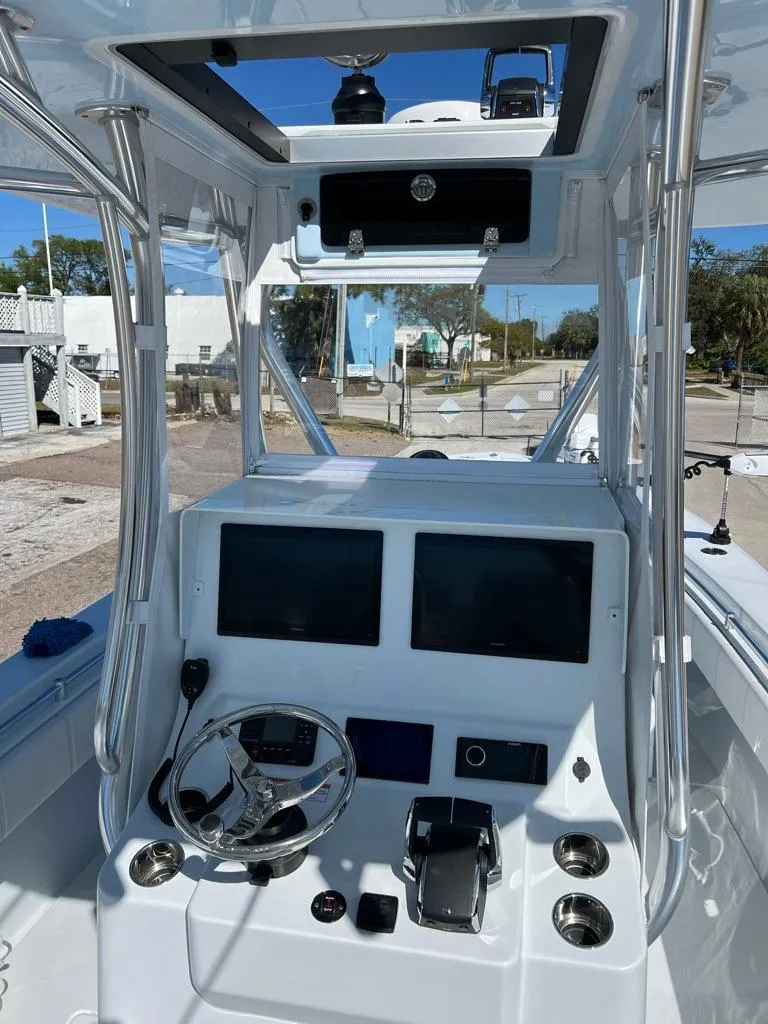 Slide: The Image of 2025 Contender 32 ST boat cockpit with dual screens and modern controls. - 5